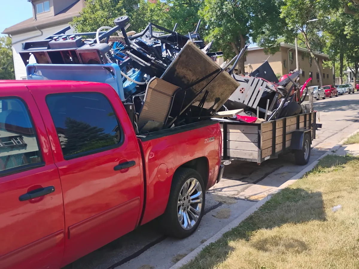 Pickup truck and trailer loaded with old furniture