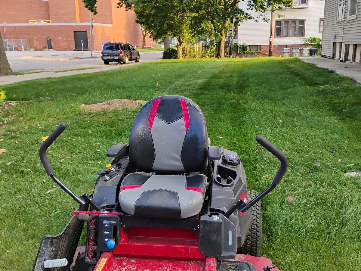 Red zero-turn mower on a freshly cut lawn