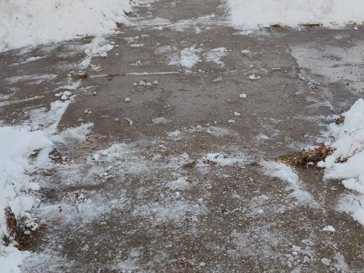 Concrete walkway cleared of snow and ice